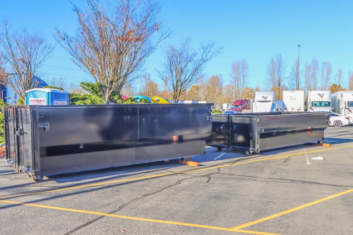 Professional dumpster rental service with roll-off container on residential driveway in Thomaston